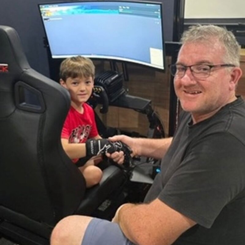 Father and son enjoying an Everything Simulated racing rig